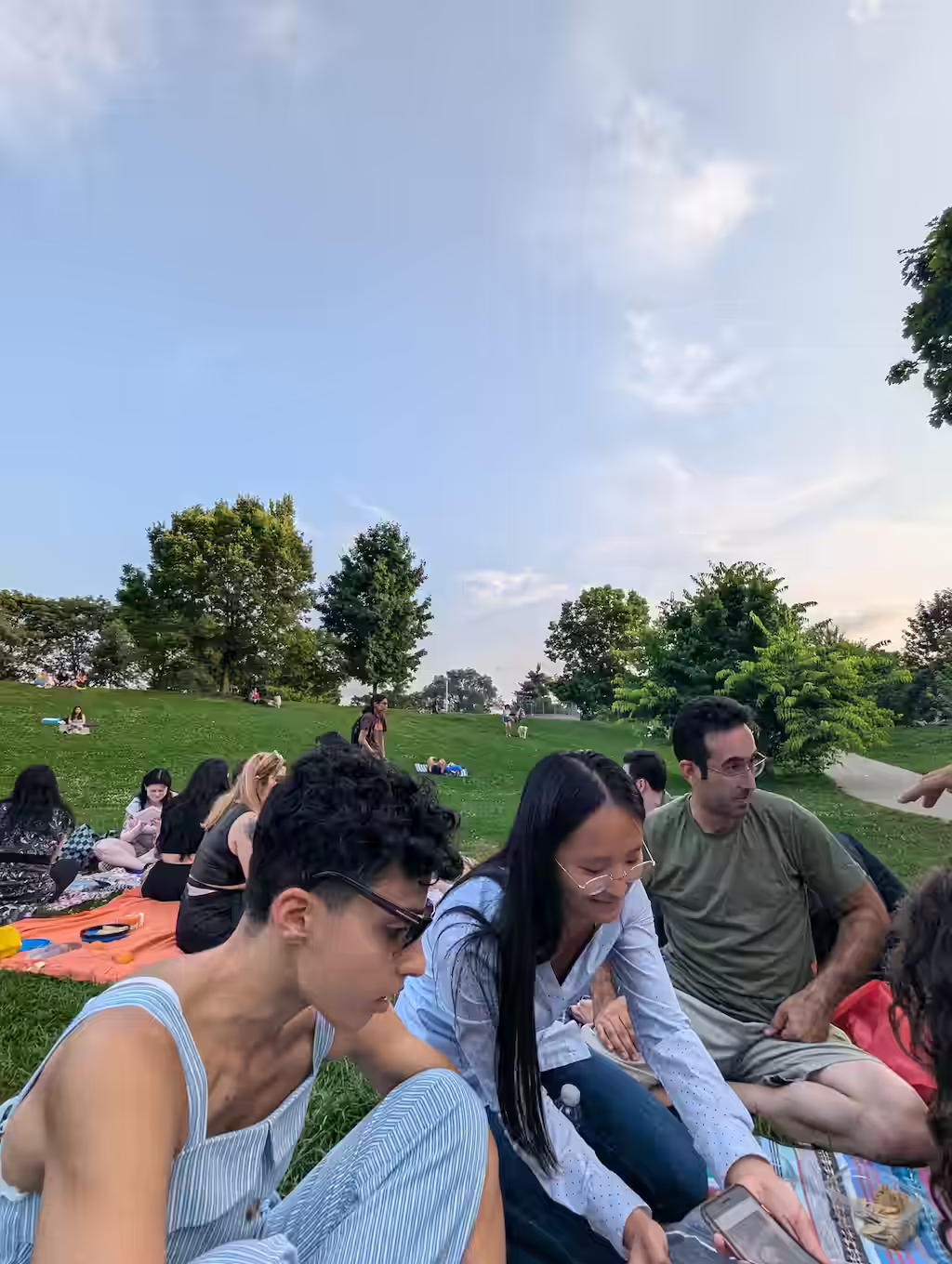 Enjoyers of clouds sitting on picnic blankets
