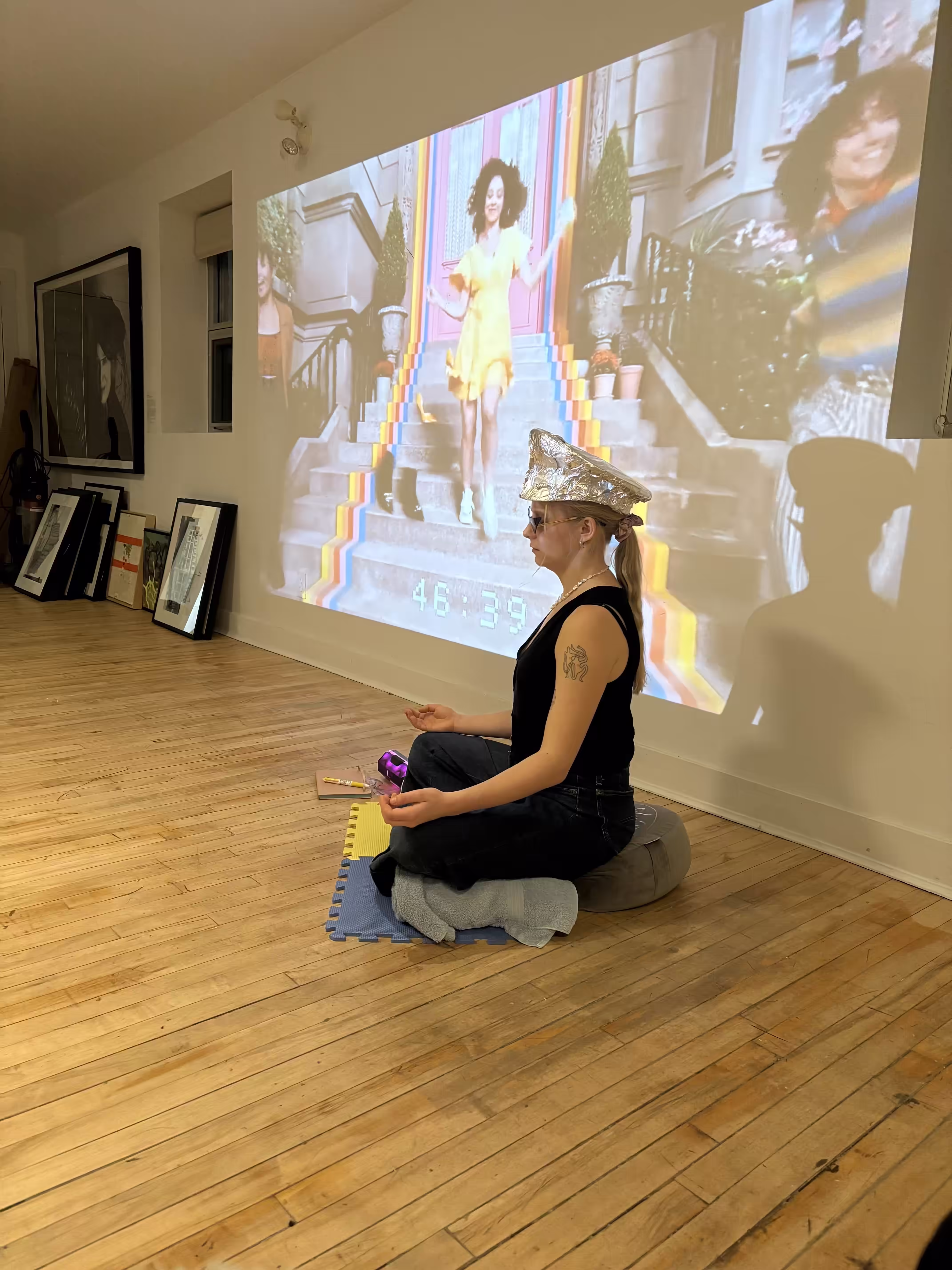 Liza meditating in front of Temu ad