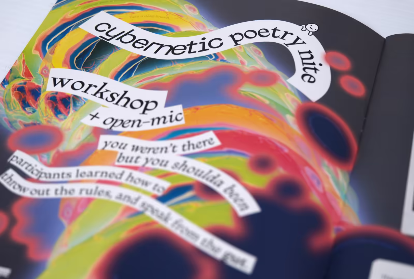 Hijinx World magazine spread titled 'Cybernetic Poetry Nite,' with text curling around clouds of fluorescent shapes.