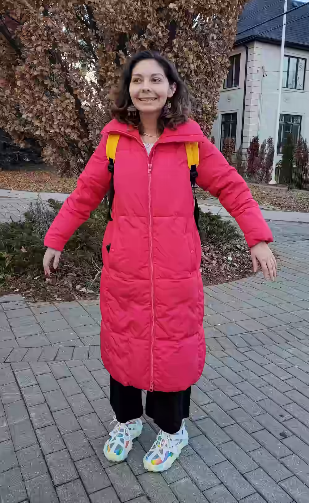 Photo of Lonny, wearing her iconic pink jacket and big rainbow sneakers.